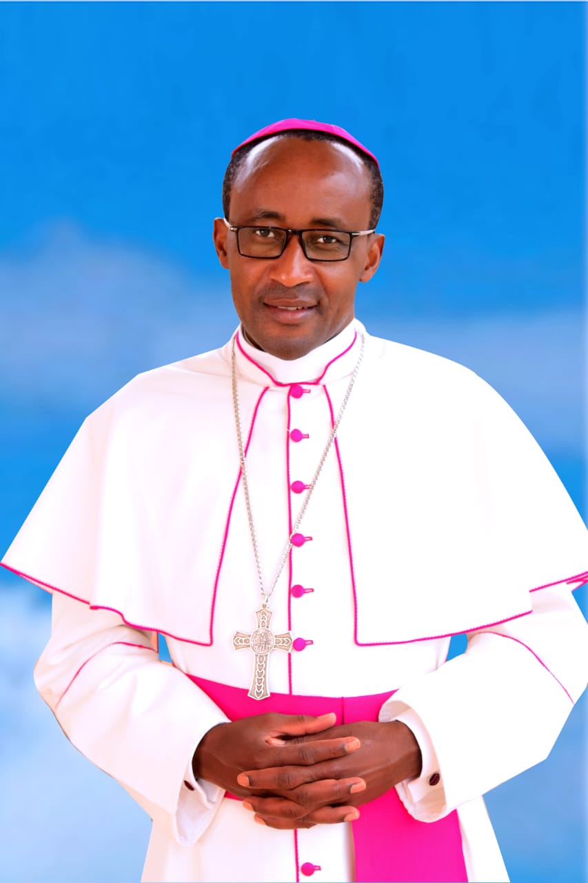 Bishop Édouard Sinayobye in liturgical vestments against a blue background.