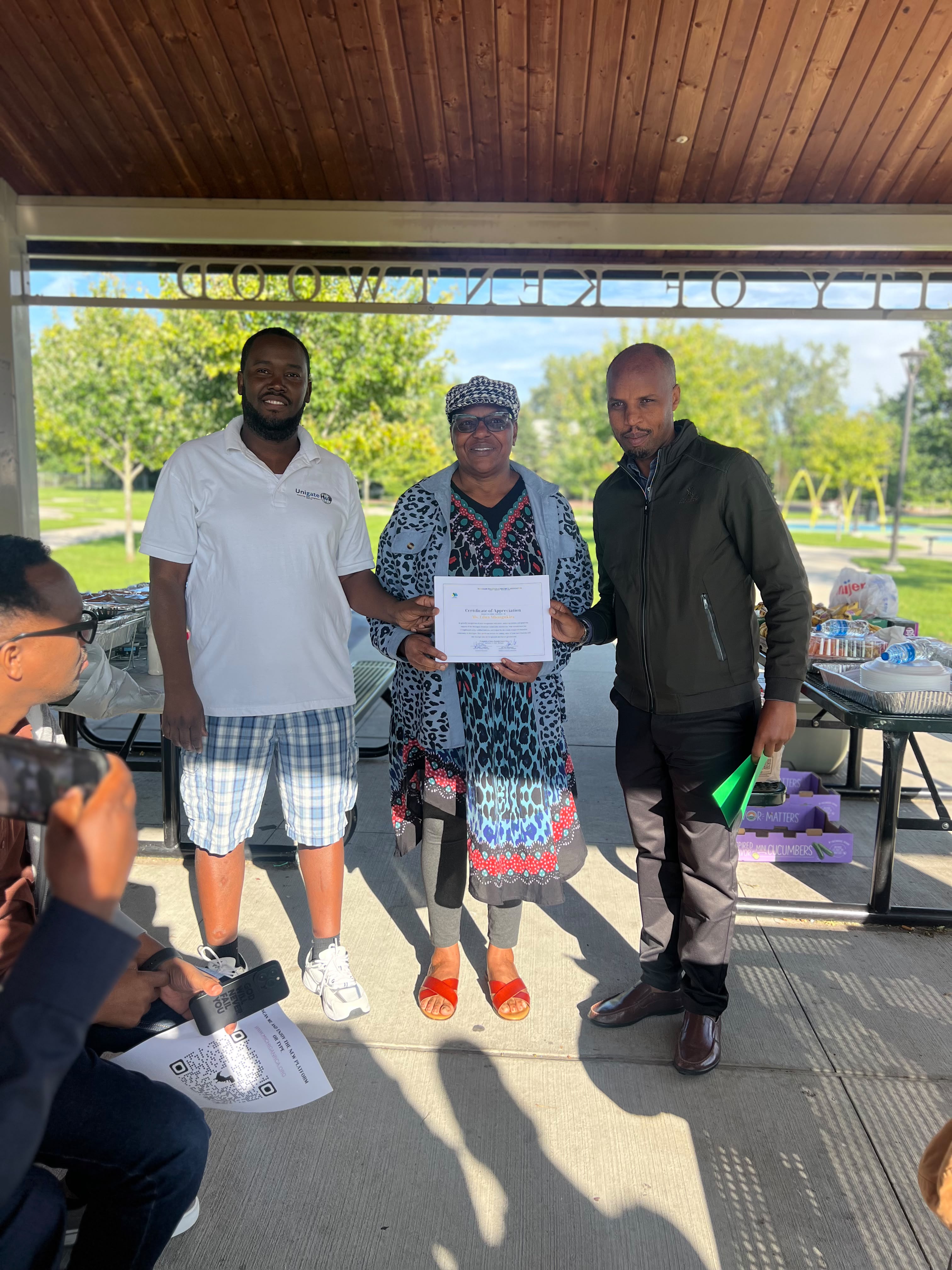 Madam Edna Mbangukira receives a Certificate of Appreciation during Iwacu Rwanda Family Day in Michigan.
