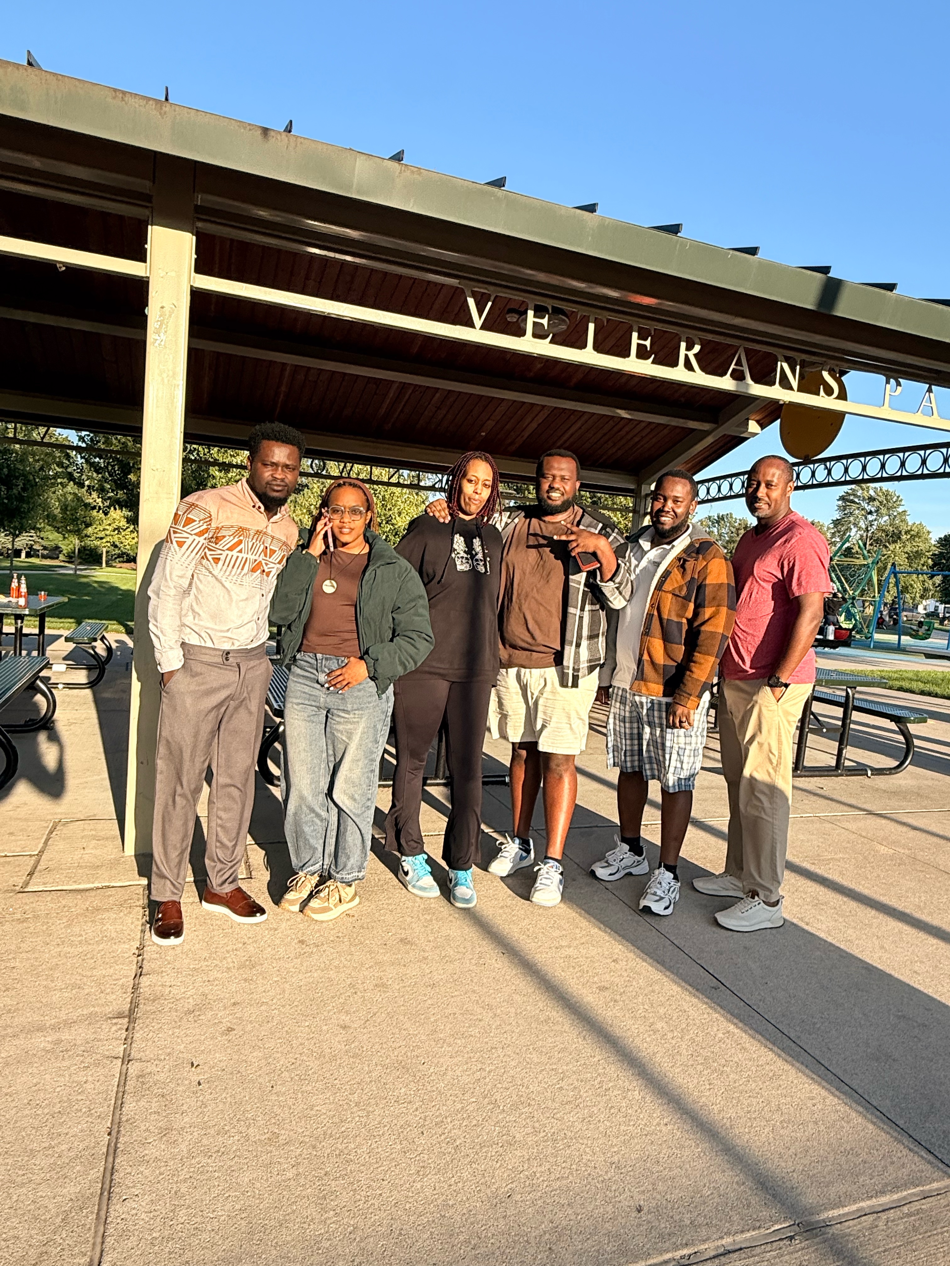 Community members gather together outdoors during Iwacu Rwanda Family Day in Michigan.
