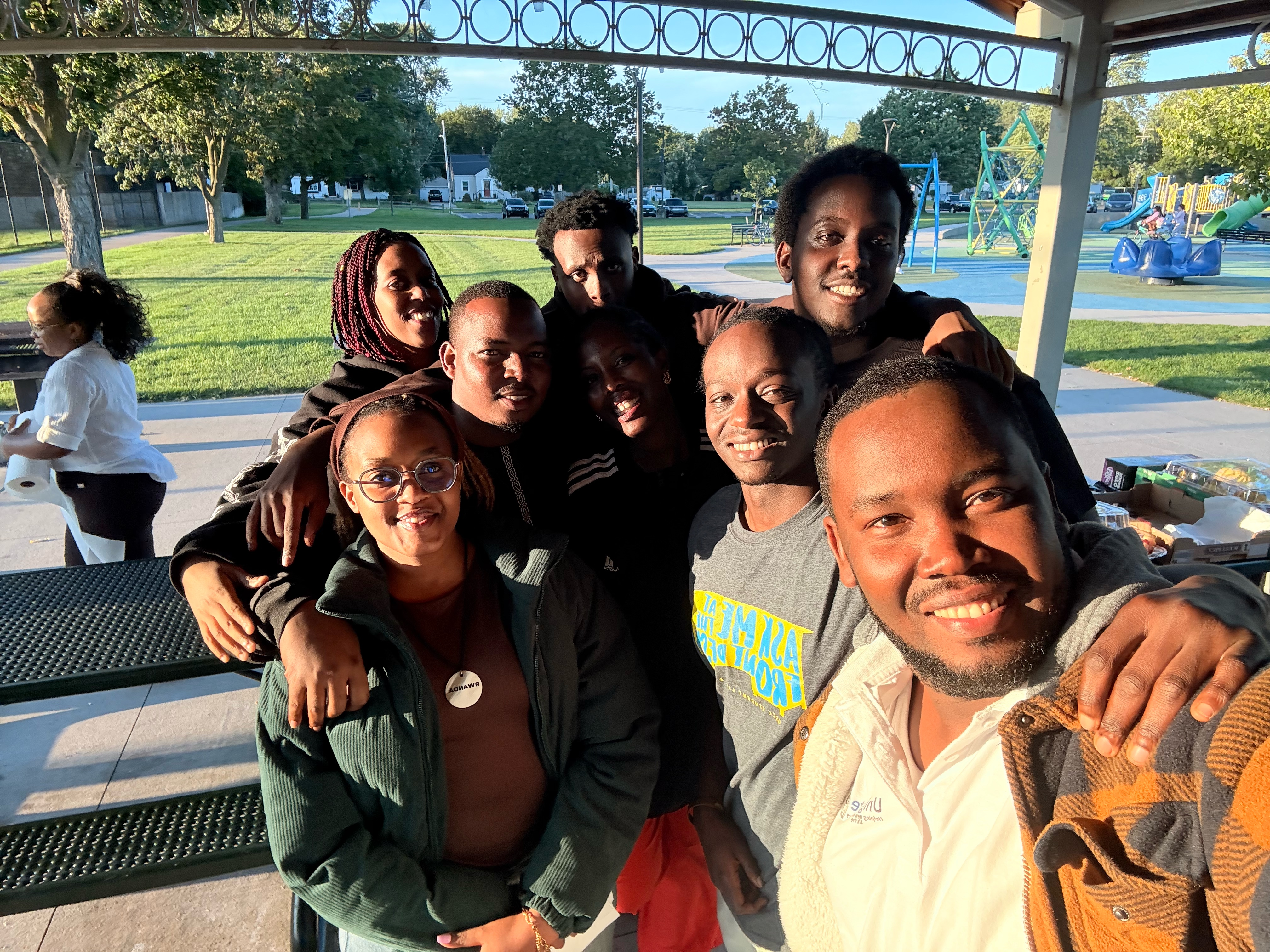 Friends and community members pose together during the outdoor family gathering.